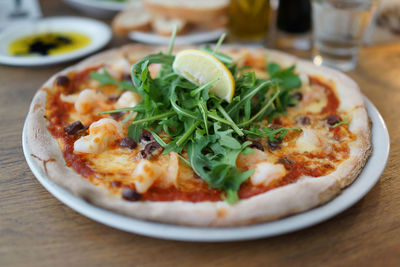 Close-up of pizza served on table