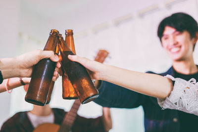 Friends toasting drinks during christmas party