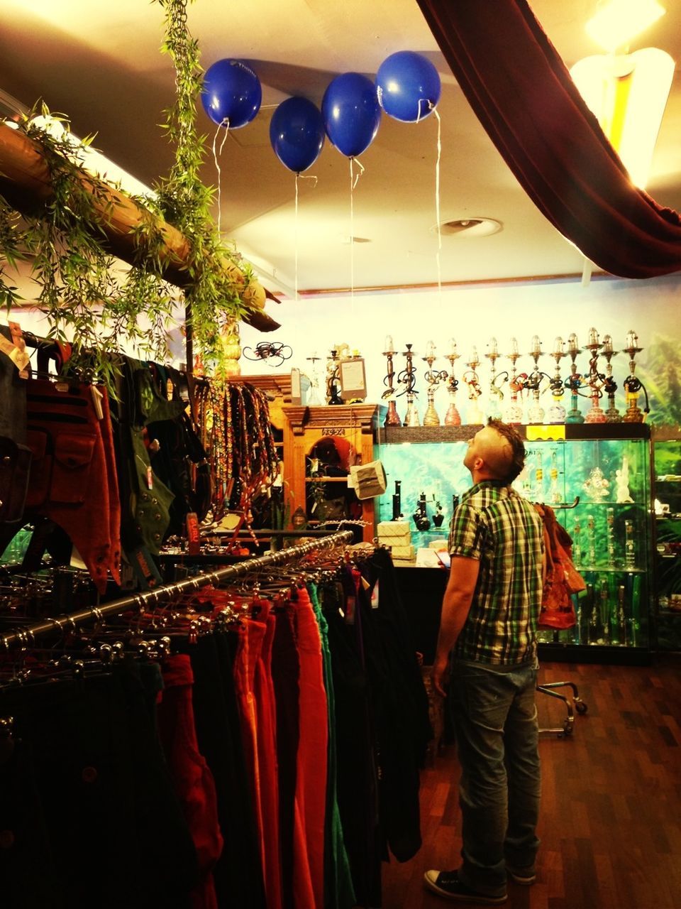 hanging, indoors, retail, choice, decoration, variation, large group of objects, celebration, in a row, for sale, market stall, arrangement, illuminated, restaurant, person, multi colored, lighting equipment, store, market