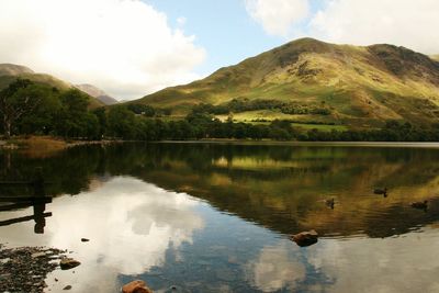 Scenic view of lake and mountains against sky