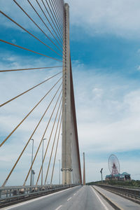 View of suspension bridge against cloudy sky