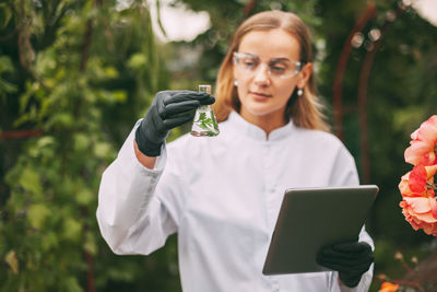 Young woman working on plant