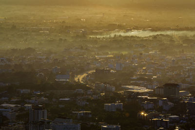 Aerial view of illuminated cityscape against sky