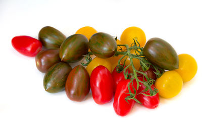 Close-up of tomatoes over white background