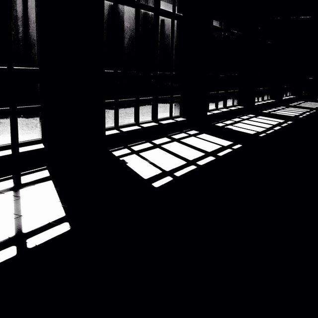 window, indoors, architecture, built structure, dark, glass - material, sunlight, shadow, night, building exterior, silhouette, transparent, railing, illuminated, building, reflection, no people, house, city