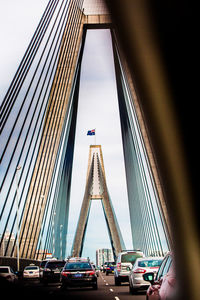View of suspension bridge in city against sky