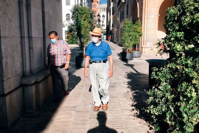 People walking on road amidst buildings