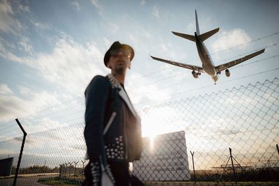 Low angle view of man playing basketball against sky