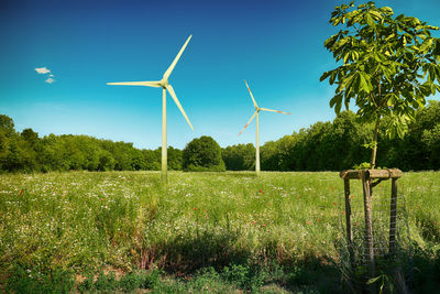 Windmill on field against sky