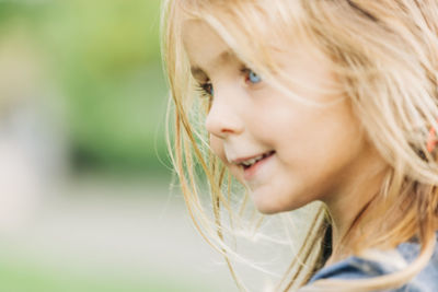 Close-up of smiling girl looking away