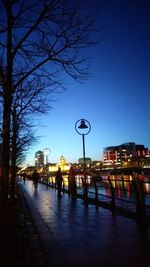 Illuminated street light against blue sky