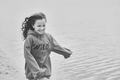 Black and white photo of a girl running along the seashore. happy little girl on summer vacation