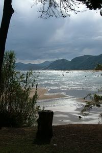 Scenic shot of calm sea against cloudy sky