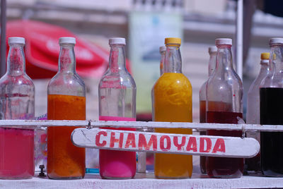 Close-up of ready-to-use chamoyada bottles in the market square of merida, yucatan, mexico