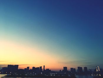 Cityscape against clear blue sky