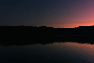 Scenic view of silhouette at night against sky