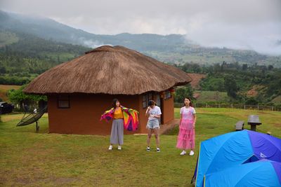 Rear view of people walking on road against sky