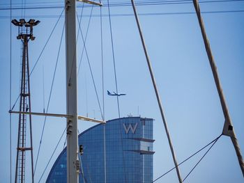 Low angle view of sailboat against clear blue sky