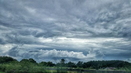 Scenic view of landscape against cloudy sky