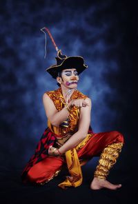 Low angle view of man sitting in traditional clothing