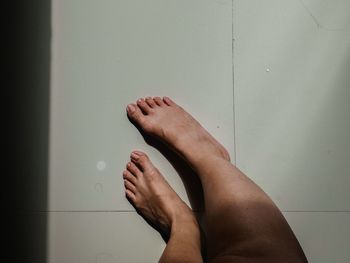 Low section of woman legs on floor