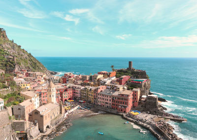 High angle view of townscape by sea against sky