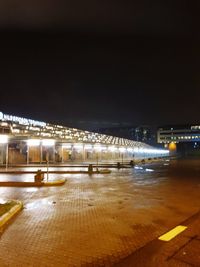 Illuminated city street at night