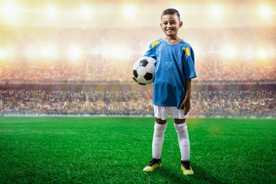 Full length of woman standing on soccer field