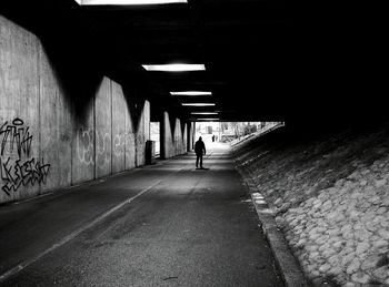 Woman walking in tunnel