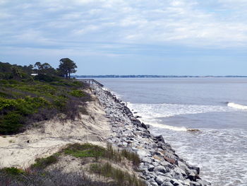 Scenic view of calm sea against cloudy sky