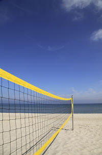 Scenic view of beach against blue sky