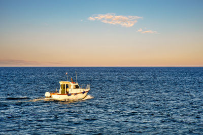 Fishing boat at sunset, liguria, italy
