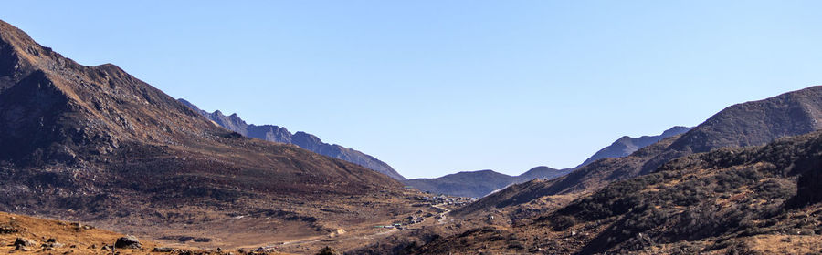 Scenic view of rocky mountains against clear blue sky