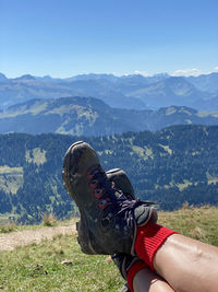 A pair of hiking boots against the mountain range