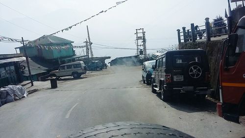 Cars on train against sky