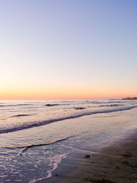 Scenic view of sea against clear sky during sunset