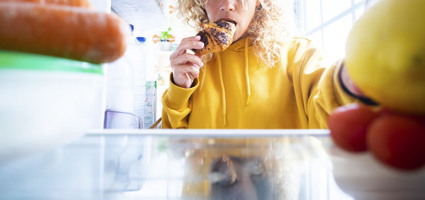 Midsection of woman holding ice cream