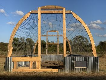 Built structure on field against sky