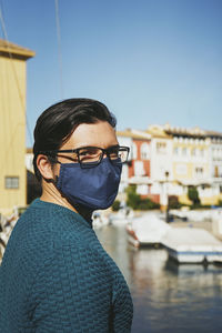 Portrait of man wearing sunglasses standing against sky