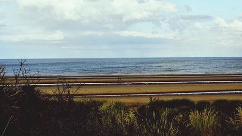 Scenic view of sea against cloudy sky