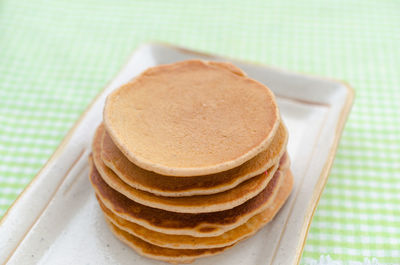 Close-up of pancakes in plate on table