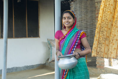 Portrait of a smiling young woman wearing sari in rural india