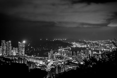 Aerial view of illuminated cityscape against sky at night