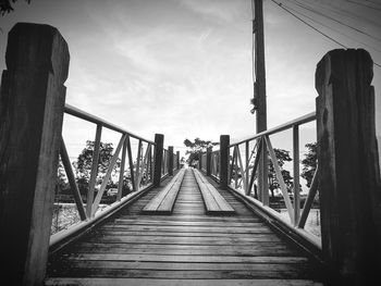 Surface level of footbridge on footpath against sky