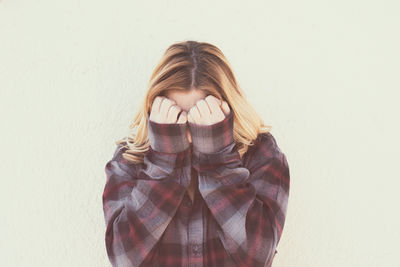 Close-up of woman covering eyes