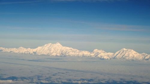 Scenic view of snow covered mountains against sky