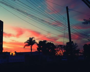 Low angle view of silhouette trees against sky at sunset