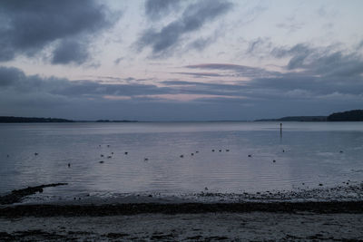 Scenic view of sea against sky at sunset