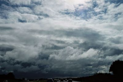 Low angle view of storm clouds over landscape