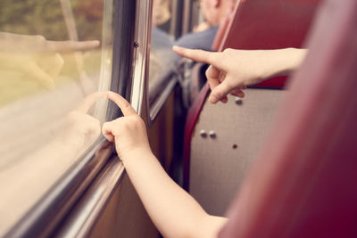 Cropped image of hand holding sunglasses